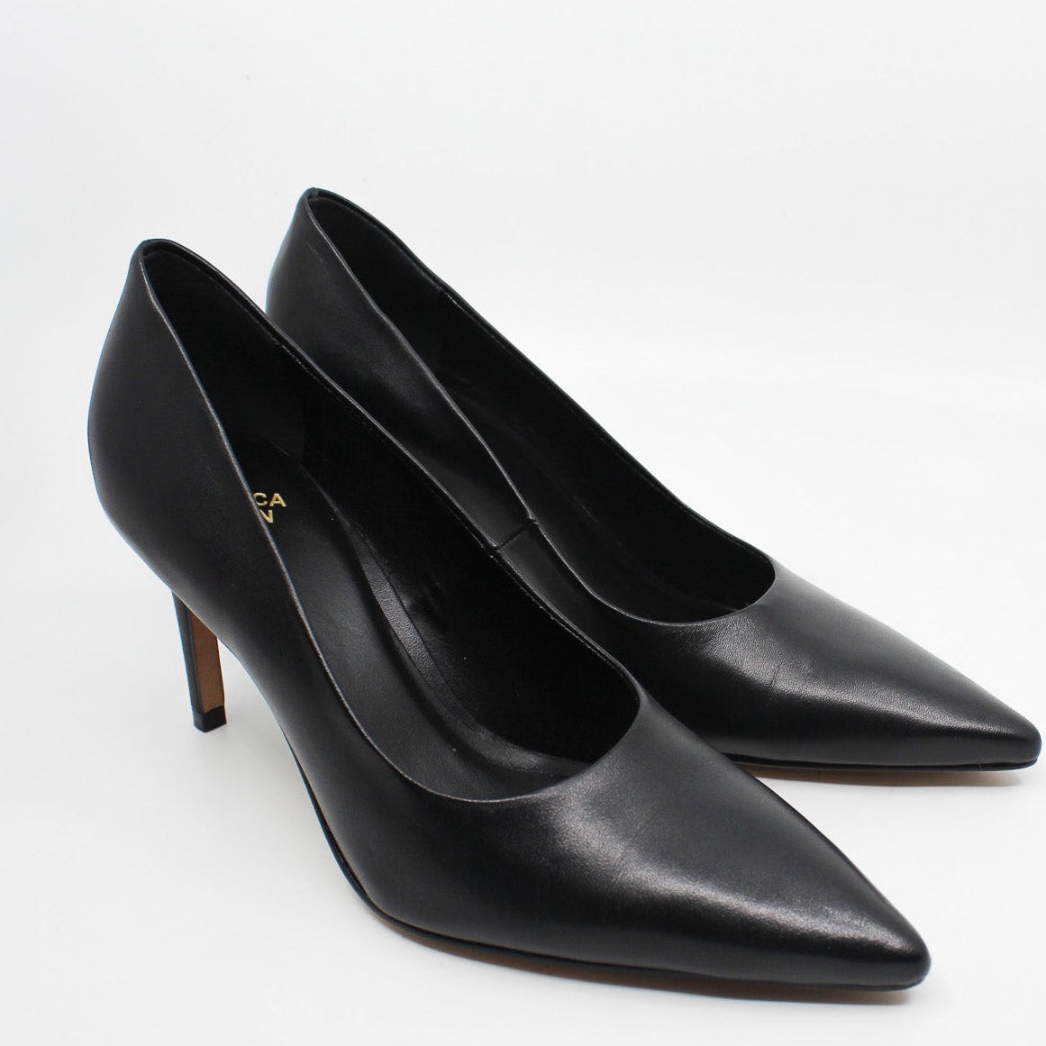 Pair of Rebecca Allen The Point pointed-toe pumps in Black leather, shown from the front three-quarter angle
