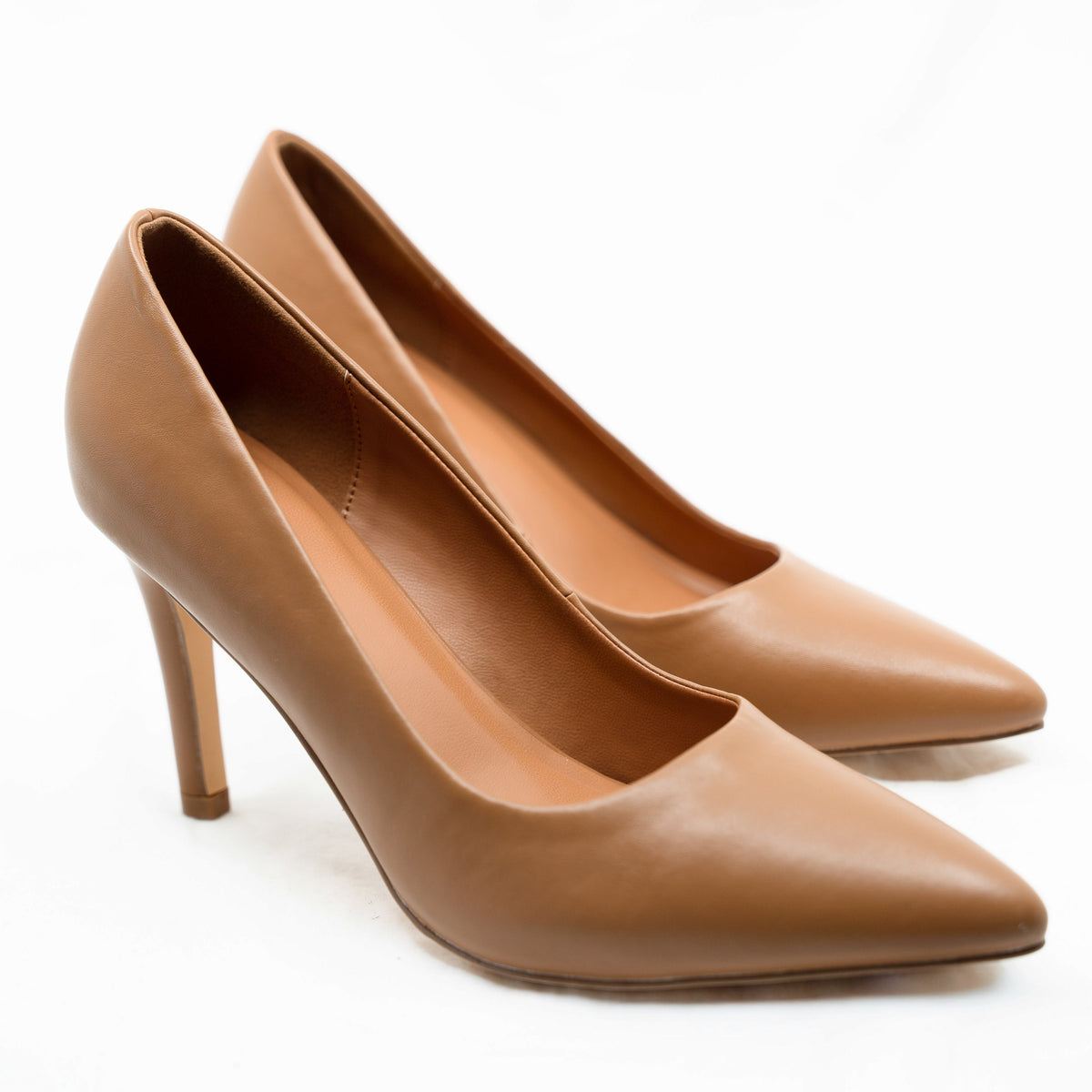 Close-up of a pair of Rebecca Allen The Point pointed-toe pumps in Nude III, a warm caramel, shown from the front three-quarter angle